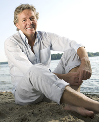 Photo of a man sitting on the beach