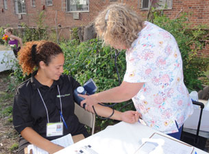 Photo of woman undergoing blood pressure screening