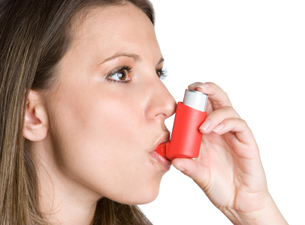 Photo of a woman using an inhaler