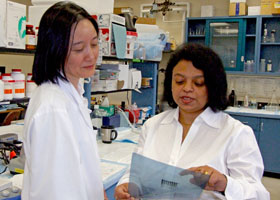 Photo of Nilanjana Maulik talking with her research assistant Lijun Zhan