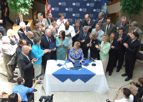 Photo of Gov. M. Jodi Rell signing legislation