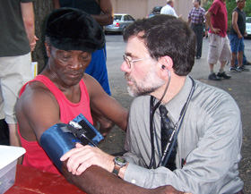 Dr. Bruce Gould examines a seasonal worker at the Thrall Tobacco Farm in Enfield in July of 2007, providing care as a physician with the Mobile Free Migrant Farm Workers Clinic.