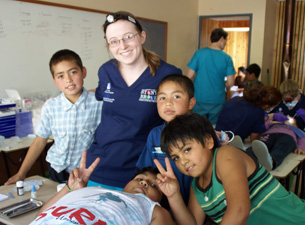 UConn dental student Jenn Merry treating children in Curarrehue, Chile. 