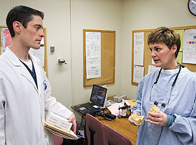 Dr. Jacqueline Duncan, associate clinical professor, speaks with third-year student Nathan West in the dental clinic.