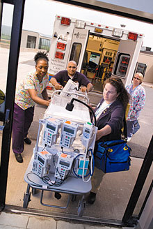 A neonatal intensive care transport team unloads an incubator from one of John Dempsey Hospital’s neonatal ambulances.
