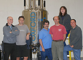 Faculty of the Health Center’s molecular, microbial and structural biology department, from left, Jeff Hoch, Michael Gryk, Martin Schiller, Stephen King, Bing Hao, and Mark Maciejewski, stand near some imaging equipment. The Health Center will soon receive a new NMR spectroscope, thanks to an NIH grant.