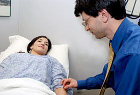 Dr. Adam Simmons demonstrates acupuncture at the Health Center.