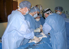 Photo of Dr. Christopher Hughes operating on a patient