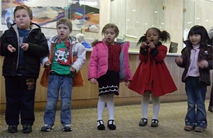 Photo of children singing holiday carols