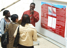 Photo of Pernell Rogers doing a poster presentation on drug abuse and oral health