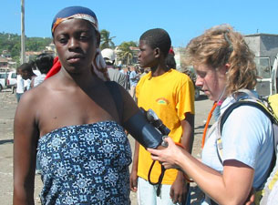 Photo of Devon Root checking the blood pressure of a pregnant woman