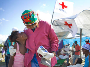 Photo of a volunteer comforting an injured child