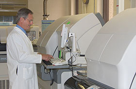 Dr. Sidney Hopfer, a professor of pathology and laboratory medicine, checks the progress of blood vials as they pass through the Health Center’s automated system.