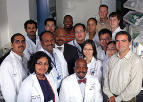 Photo of Dr. Cato T. Laurencin in his research lab with a group of scientists he mentors. 