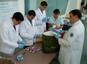 Volunteers sort through and record the collected medications