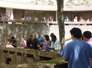 Faculty, staff, students and volunteers enjoying lunch in the courtyard