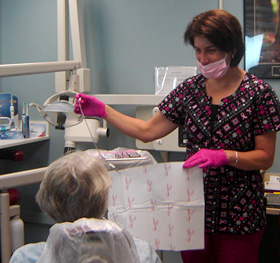 Photo of dental hygienist Karen Pirro with a patient.