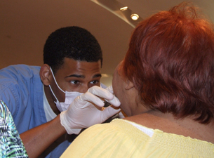 Photo of Marcus Moss examining a patient