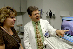 Speech pathologist Janet Rovalino and Dr. Denis Lafreniere of the Health Center’s Voice and Speech Clinic, review a video image of a patient’s vocal cords.