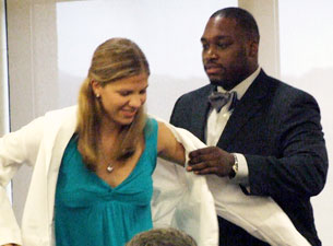 Female student being presented with a white coat